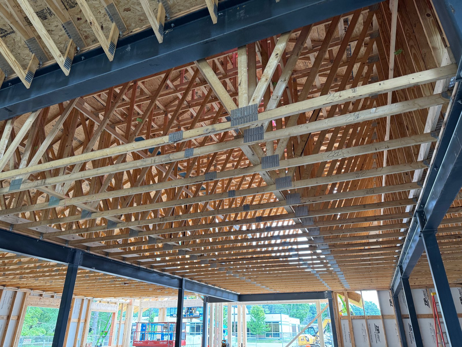 Interior wood and steel truss framing on a Lakeshore Construction project in Vermont