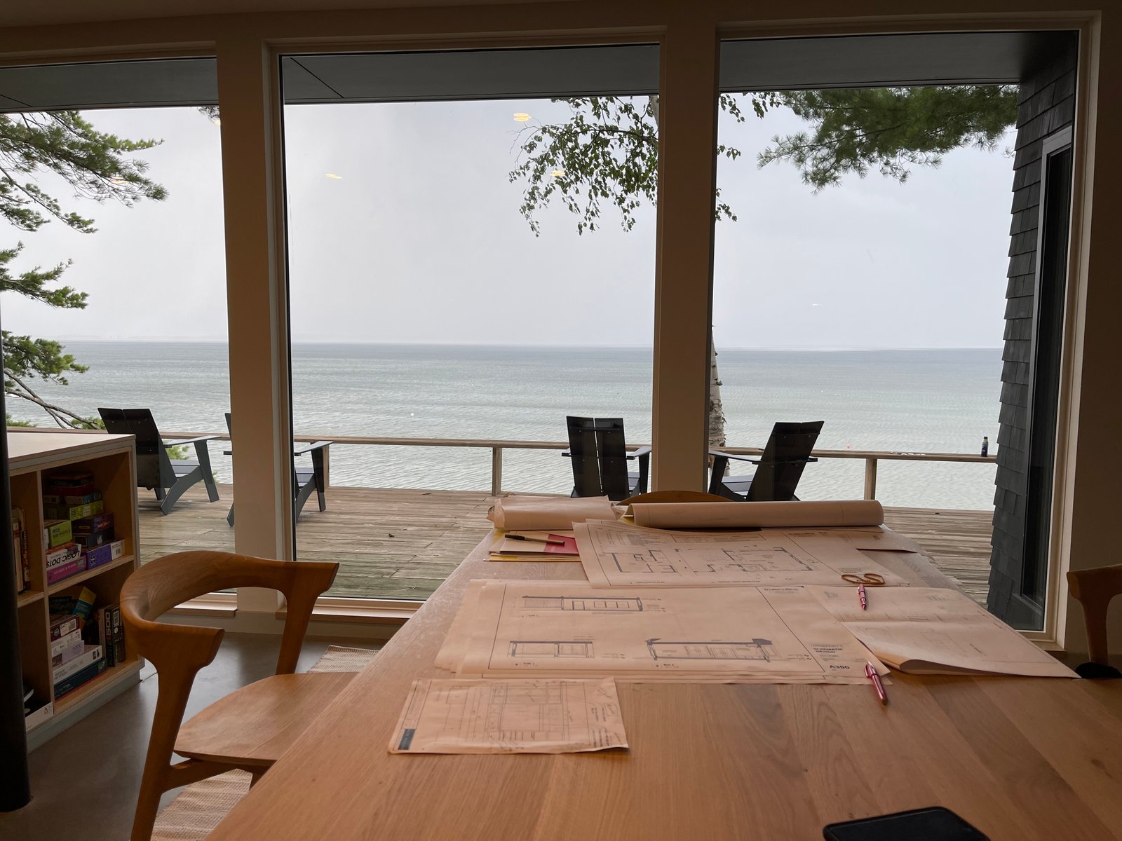 Design plans on a table overlooking Lake Champlain from a Lakeshore Construction home