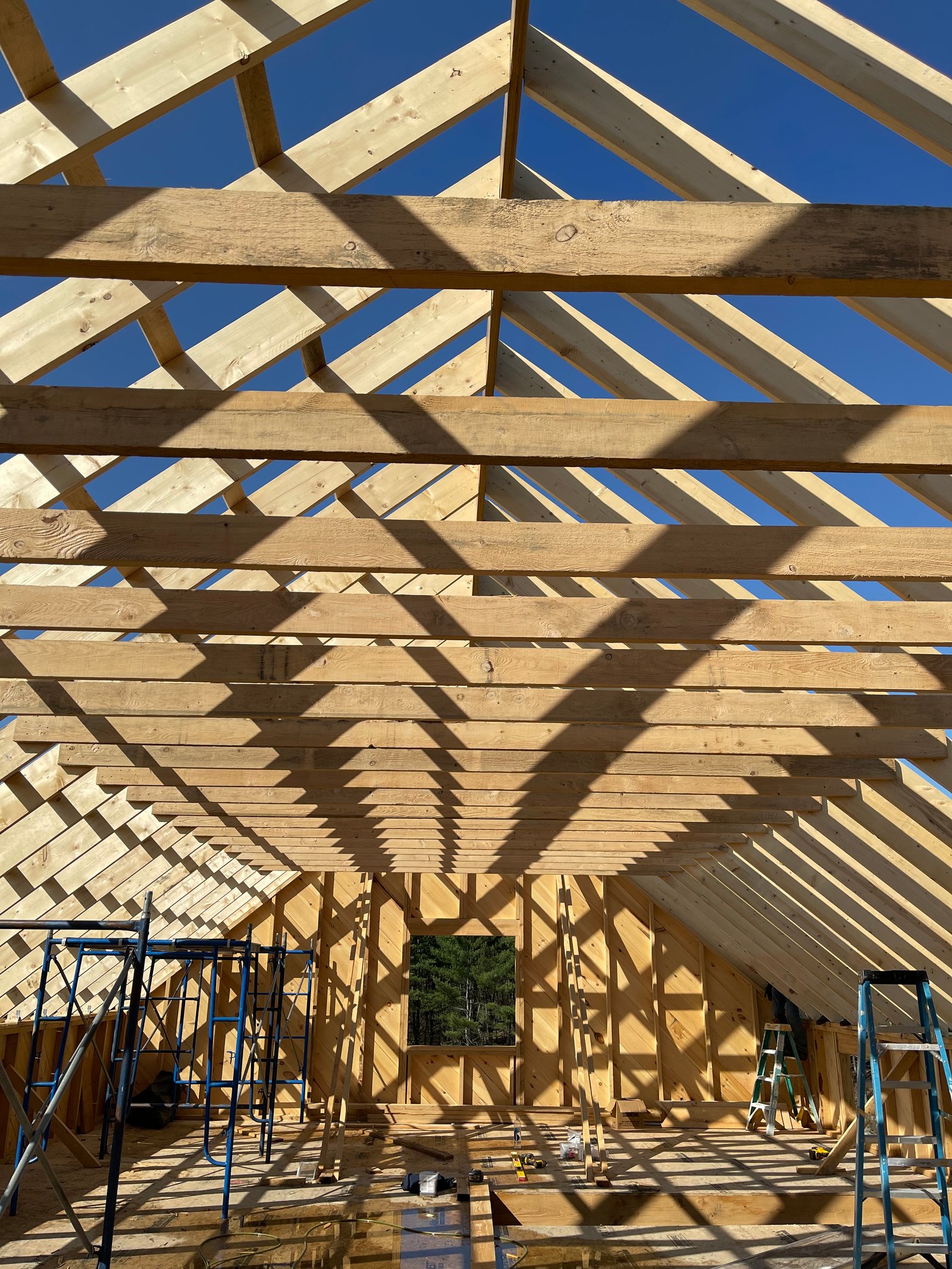 Roof framing detail against a clear blue sky on a Lakeshore Construction build in Vermont