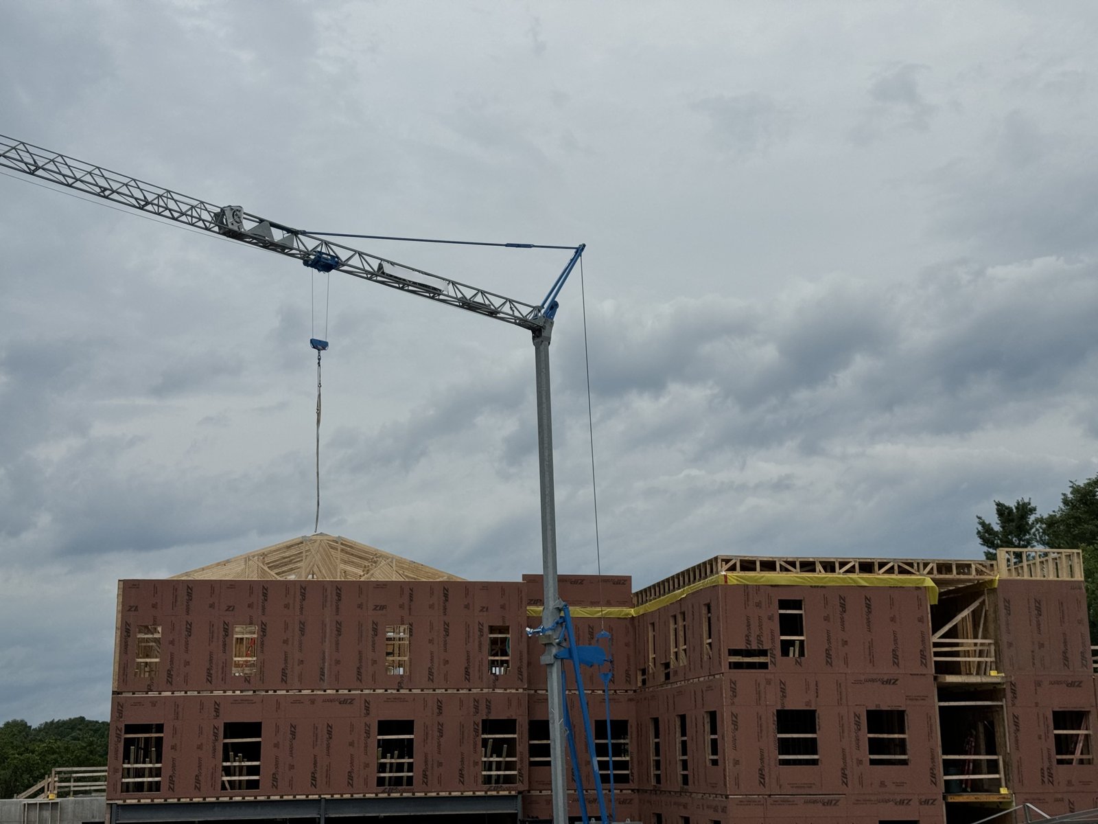 Multi-story building being framed with a tower crane on site in Vermont