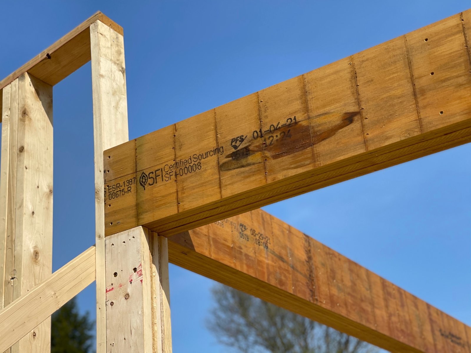 Structural framing beam detail against a clear blue sky
